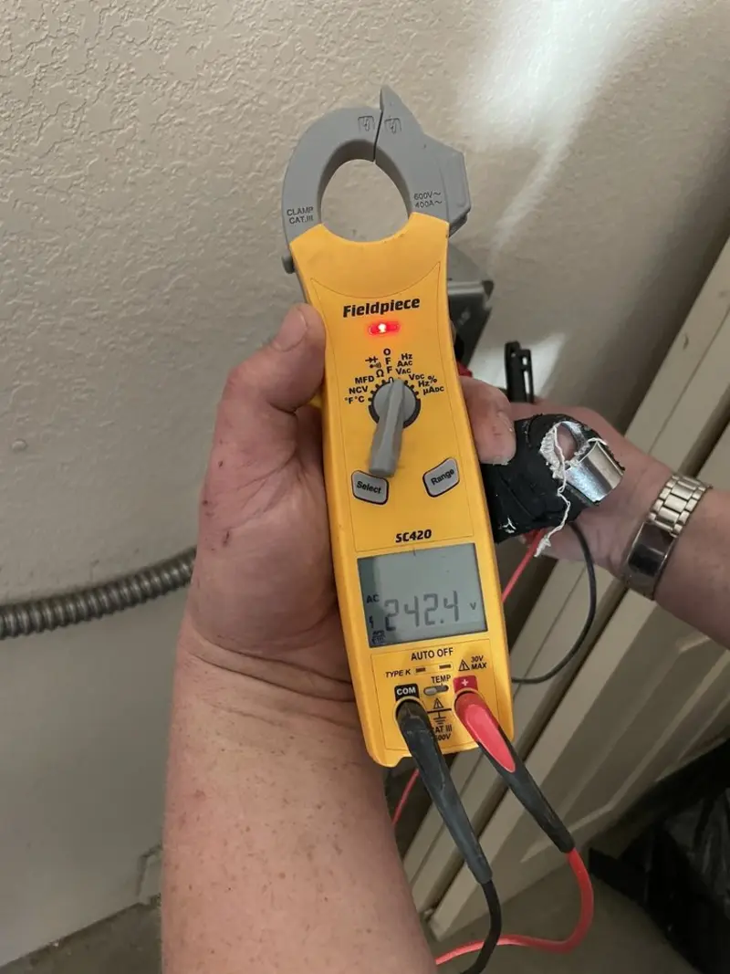 Voltage testing with clamp meter during Recessed Lighting Installation in Houghton